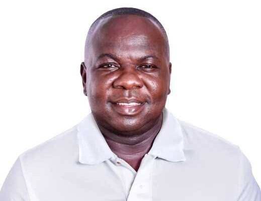 Smiling man in a white polo shirt posing for a portrait against a white background, suitable as a headshot