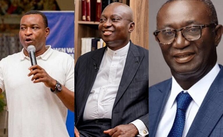 Three men in a row: left speaks into a microphone, middle smiles in a suit, right wears glasses in a blue suit.