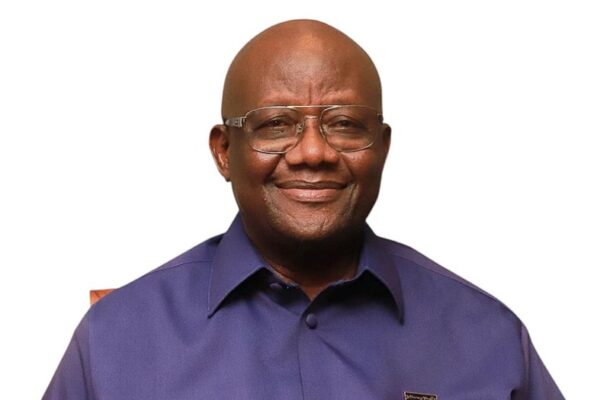 IMG-20260617-WA0014 | Ghanaguardian.com Smiling man with glasses in a purple button-down shirt, against a white background (head-and-shoulders portrait).