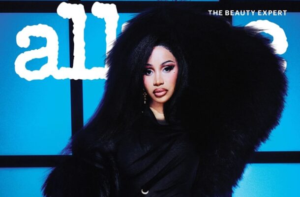 Woman wearing a dramatic black fur coat poses against a blue grid background with the word 'all' and 'THE BEAUTY EXPERT' visible.