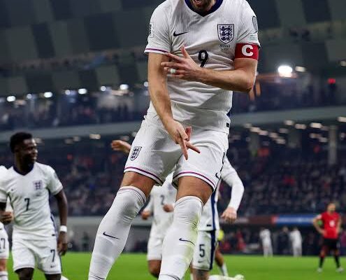 IMG_0857 | Ghanaguardian.com England captain wearing white kit with armband jumps in celebration on a football pitch with pink boots during a match