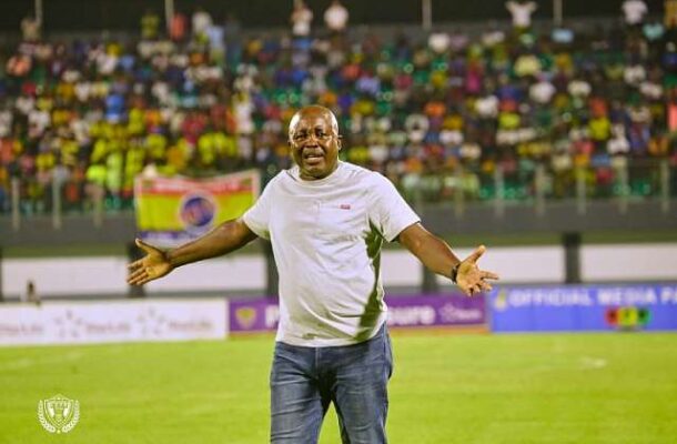 IMG_0869 | Ghanaguardian.com Man in a white shirt on a soccer field with arms outstretched, cheering crowds in the background.