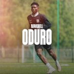 Soccer player Maxwell Oduro training on a green field, with bold 'ODURO' text overlay and club crest in the foreground.