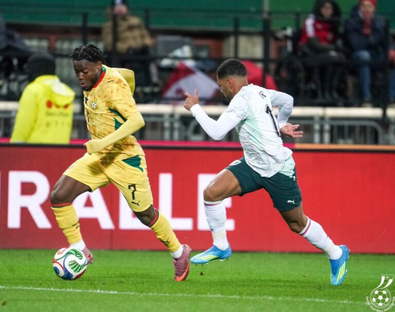 Two soccer players sprint for the ball during a match, the yellow-clad player wearing number 7 in the lead while the opponent in white and teal pursues closely.