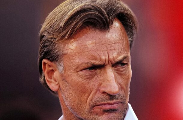 Close-up of a man in a white shirt on a red poster with bold white text and a small circular logo above.