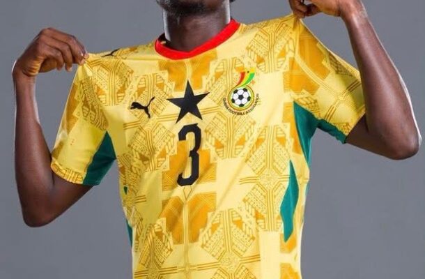 IMG_0977 | Ghanaguardian.com Young male soccer player posing in a yellow jersey with number 3, pulling the sides to show the shirt, against a gray backdrop.