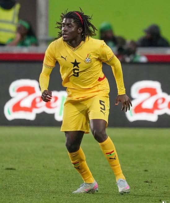 Action shot of a soccer player in a yellow uniform (number 5) sprinting on the pitch during a match.