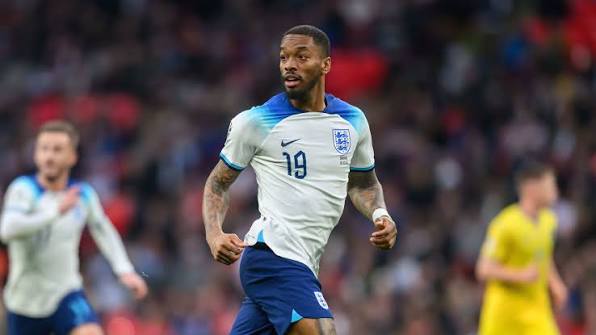 England footballer in white and blue kit with number 19 running on the pitch during a match.