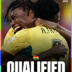 Two Ghanaian football players embrace in celebration, with the word 'QUALIFIED' and 'ROUND OF 32' on a graphic that includes the FIFA World Cup 2026 logo.