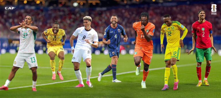 Group of diverse soccer players in colorful uniforms celebrating on a green field during a game banner.