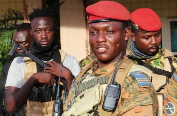 xrdDAFMql2t51o2188j44504451872t23040307 | Ghanaguardian.com Three armed soldiers in camouflage and red berets stand together, the central figure wearing a tactical vest and radio.
