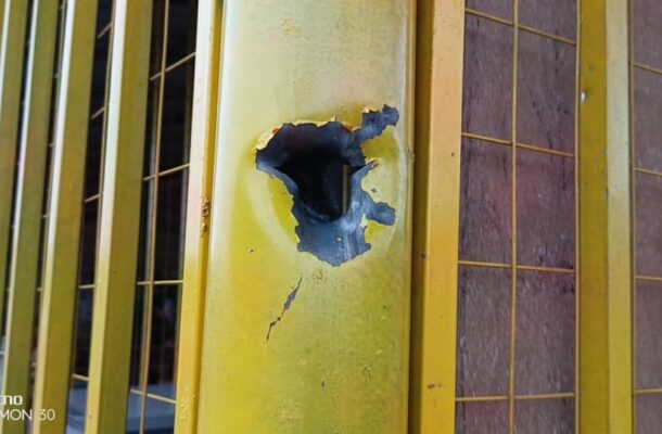 Momo vendor killed | Ghanaguardian.com Close-up of a yellow metal gate with a large torn hole and visible cracks in the panel.