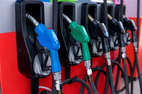 OIP-2 | Ghanaguardian.com Gasoline pumps at a station with blue, green, and black nozzles and coiled hoses.