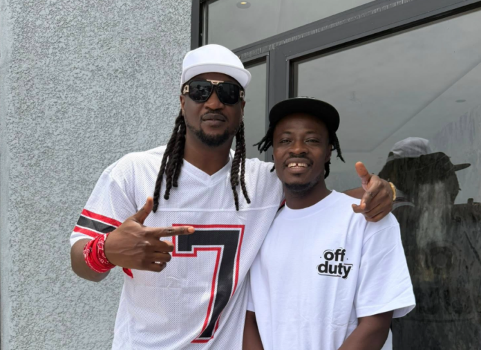 Two men posing outside a building; left man wears a white cap, sunglasses, and a white jersey with a large number 7, right man wears a white T‑shirt that says 'off duty'.