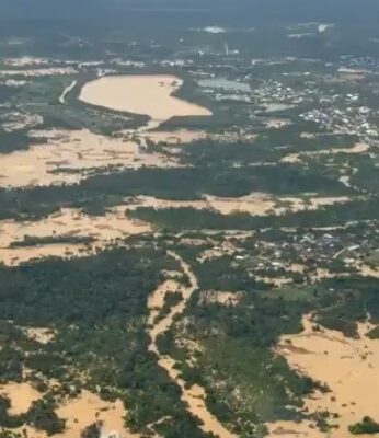 Samreboi | Ghanaguardian.com Aerial view of a sandy coast with winding riverlike channels and clusters of green vegetation, with a small town visible in the distance.