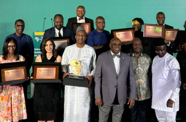 Screenshot 2026-06-13 145520 | Ghanaguardian.com Group of award recipients posing with framed plaques on a stage during a ceremony.