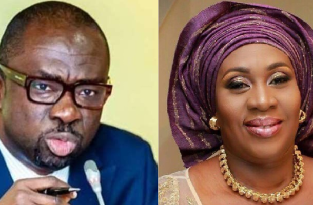 Two side-by-side portraits: a man in a suit speaking into a microphone, and a smiling woman wearing a purple head wrap with gold jewelry.
