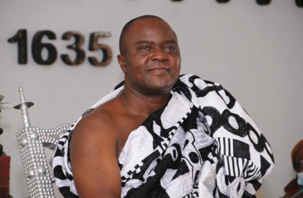 WhatsApp Image 2026-05-21 at 104956 AM | Ghanaguardian.com Man wearing a black-and-white patterned towel over his shoulders, sitting on a decorative chair in a ceremonial setting.