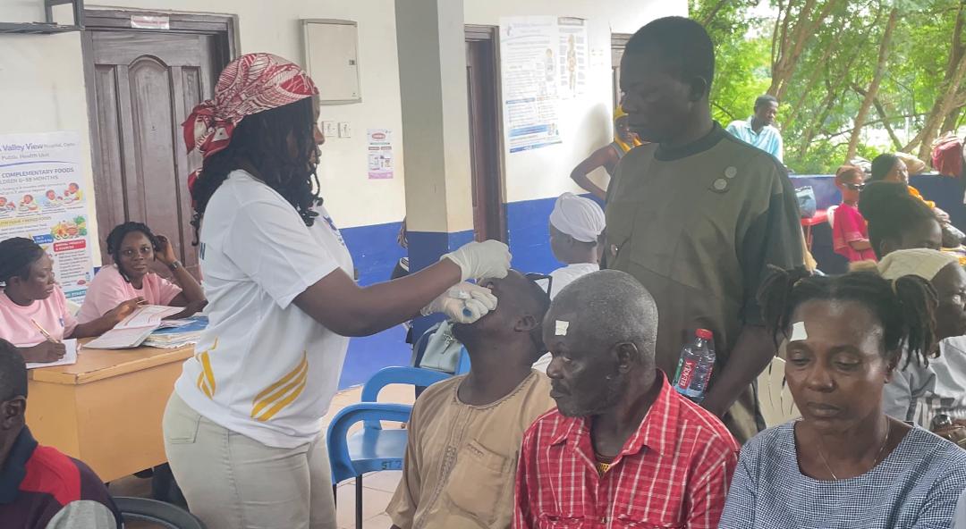 WhatsApp Image 2026-06-24 at 091801 | Ghanaguardian.com Nurse in a white uniform and headscarf administers a procedure to a man reclining in a chair at a community clinic, with others waiting nearby.