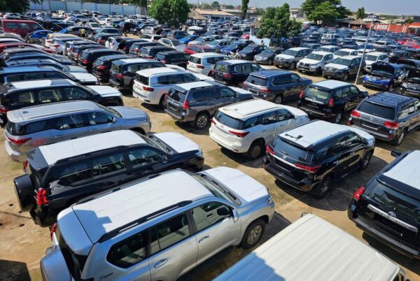 Aerial view of a crowded car dealership lot with rows of parked SUVs and crossovers.