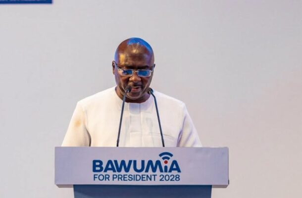 Man in white traditional attire speaks at a podium labeled 'BAWUMIA FOR PRESIDENT 2028'