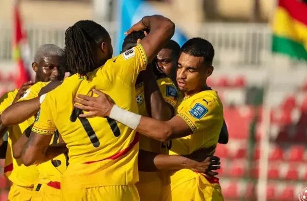 black-stars-players-672x406-1 | Ghanaguardian.com Soccer players in bright yellow jerseys celebrate with a group hug on the field, in a stadium backdrop.