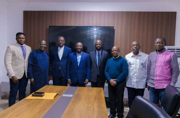 images-2026-06-08T095401181 | Ghanaguardian.com Eight men in suits and smart-casual wear pose in a conference room behind a long wooden table.