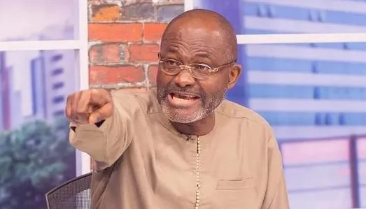Angry-looking man wearing a beige traditional outfit points his finger at the camera in a tense moment.