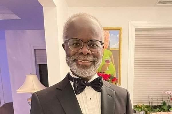 nduom 1 | Ghanaguardian.com Smiling older man in a black tuxedo, white shirt, and bow tie, wearing round glasses, indoors at a social event.