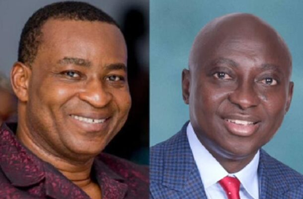 45821589 | Ghanaguardian.com Two men smiling side by side; left man wears a maroon patterned shirt, right man wears a blue checked suit with a red tie.