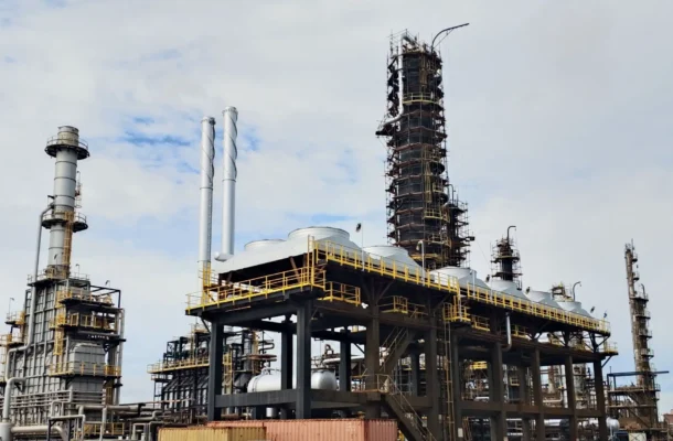 747273898_1035238062316615_7122566297577069846_n | Ghanaguardian.com Industrial refinery with tall processing tower, scaffolding, and network of pipes against a cloudy sky, highlighting industrial infrastructure.