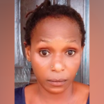 Close-up of a woman with short twists and a wide-eyed, surprised expression facing the camera.