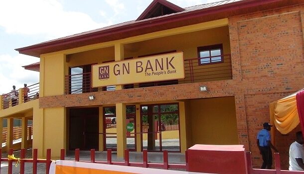 GN-Savings-and-Loans | Ghanaguardian.com Facade of a GN Bank branch with a yellow and brick exterior and a sign reading 'GN BANK The People's Bank' above the entrance; a few people near the doorway.