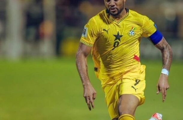 IMG_0990 | Ghanaguardian.com Ghana national team footballer in a yellow kit sprinting on a soccer field, wearing a blue captain's armband and the number 9 on the jersey.
