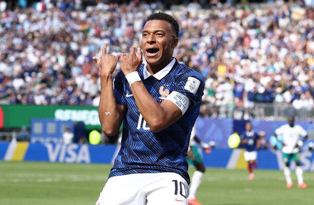 FBL-WC-2026-MATCH17-FRA-SEN | Ghanaguardian.com Soccer player in a blue kit celebrates a goal with arms raised as a packed crowd cheers in the stands.