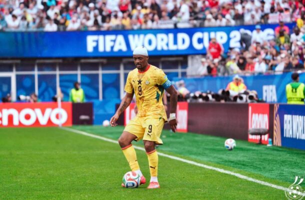 IMG_1143 | Ghanaguardian.com Soccer player in a yellow jersey (number 9) with a white headband, about to kick a ball on a bright green pitch at a FIFA World Cup match, stadium full of fans behind.