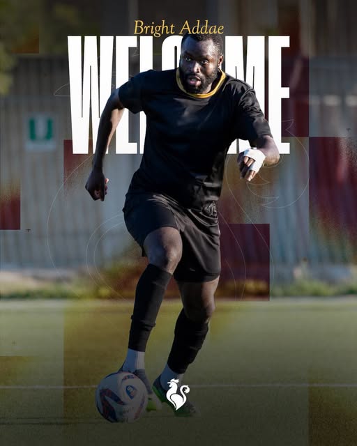 Soccer player in black kit dribbling a ball on a field, with large 'WELCOME' text and 'Bright Addae' above; small rooster emblem at the bottom.