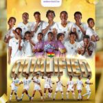 Group of Ghanaian women's soccer players in white uniforms pose together, celebrating qualification with a large 'QUALIFIED' banner and Ghana flag motif in the foreground.