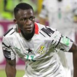 Ghana national football team player in a white kit with number 17, sprinting on the field during a match.