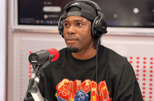 IMG_1260 | Ghanaguardian.com Radio host wearing headphones and a black cap speaks into a red mic in a studio set-up