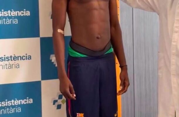 Shirtless young man is measured for height by a clinician using a stadiometer in a medical facility backdrop with logos behind him.