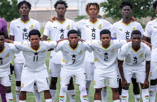 IMG_1293 | Ghanaguardian.com Group of soccer players in white uniforms posing for a team photo on a grass field, arms around shoulders, numbers visible on shirts.