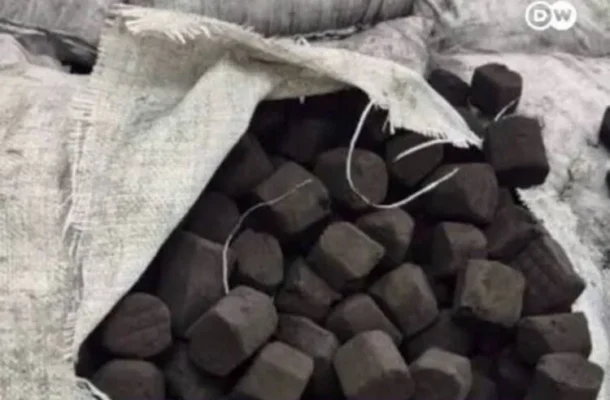 Screenshot_20260714_214442_Google-750x509-1 | Ghanaguardian.com Open burlap sack spilling with numerous dark coal chunks piled inside.