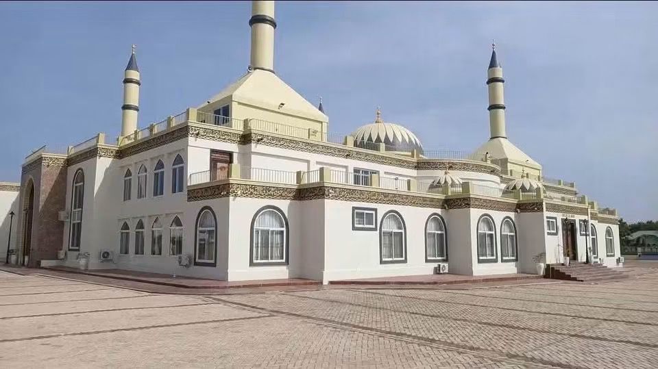 WhatsApp Image 2026-07-06 at 115552 3 | Ghanaguardian.com White mosque with domed roof and four minarets on a wide paved courtyard.