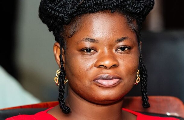 WhatsApp Image 2026-07-16 at 152624 | Ghanaguardian.com Close-up portrait of a woman with braided hair wearing a red top, looking at the camera with a neutral expression.