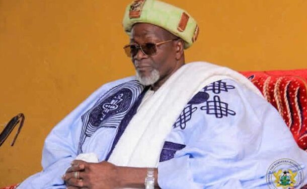 Yaa-Naa Abukari Mahama II | Ghanaguardian.com Elderly man in traditional West African clothing: white-blue agbada robe with blue patterns, green turban, sunglasses, seated with hands clasped.