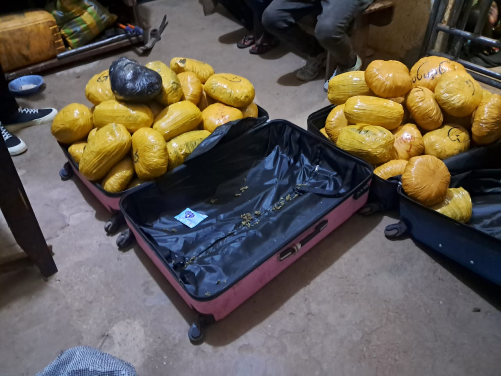 image-782-1024x768 | Ghanaguardian.com Two pink suitcases on a dusty floor filled with numerous yellow-wrapped packages. A few items lie loose inside one case.