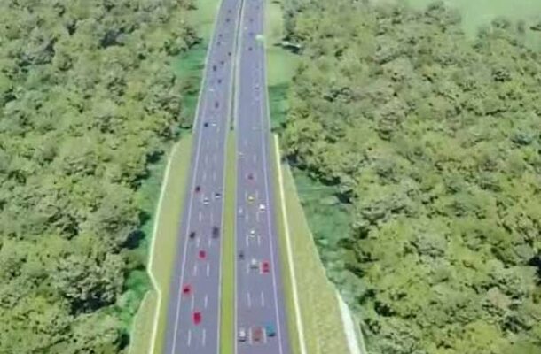 images-44 | Ghanaguardian.com Aerial view of a divided multi-lane highway cutting through dense green forest on both sides, with cars traveling in both directions.