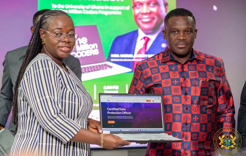 Woman hands a laptop to a man at a ceremony; screen shows 'Certified Data Protection Officer' amid a colorful backdrop.