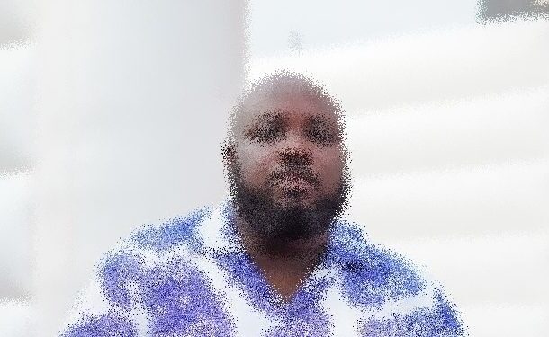 naija-man-627x375 | Ghanaguardian.com Bearded man in a light blue patterned shirt seated indoors, facing the camera.